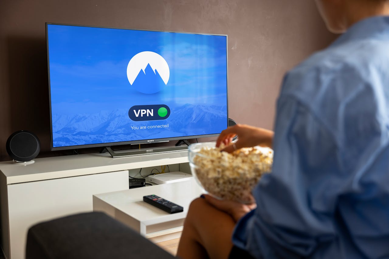 A relaxed scene at home with a person enjoying popcorn while watching a VPN-protected TV.